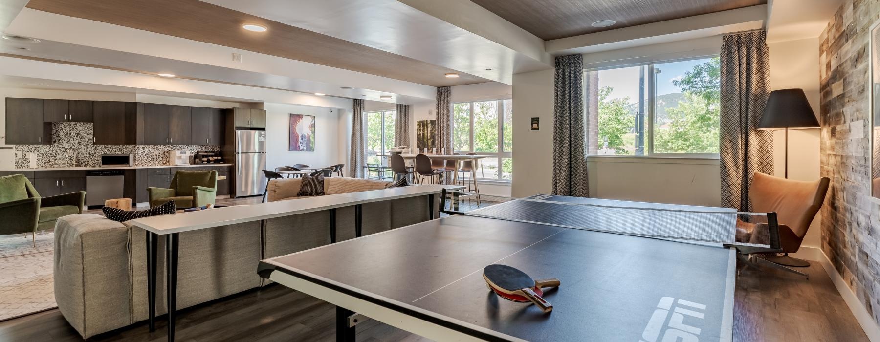 a large living room with a large table and chairs