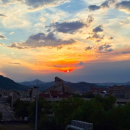 a sunset with mountains