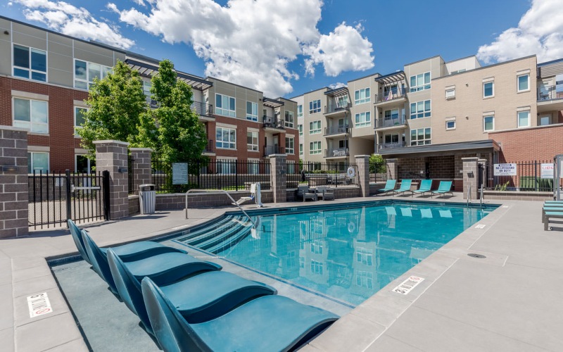 a swimming pool with lounge chairs