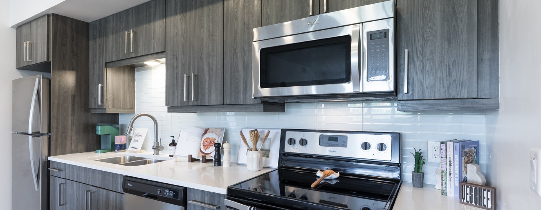 a kitchen with dark cabinets