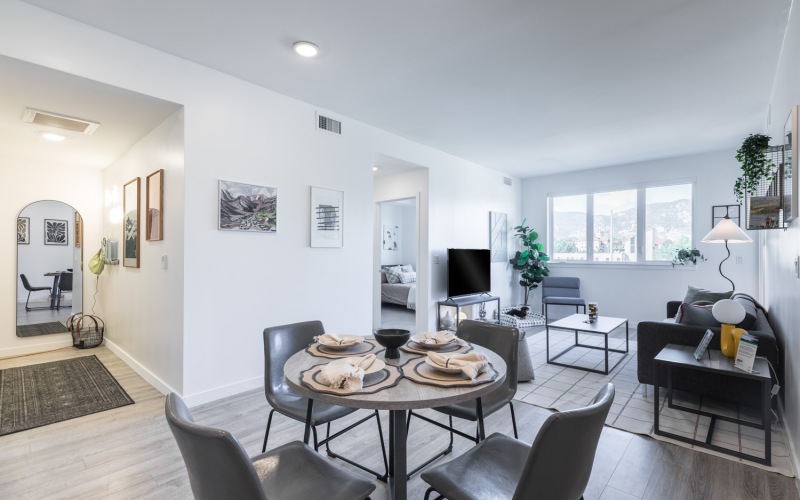 a kitchen with a couch, tables and chairs